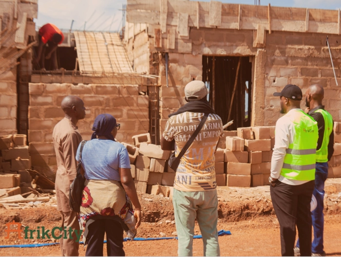 AfrikCity's Staff members at a construction site portraying one of their services